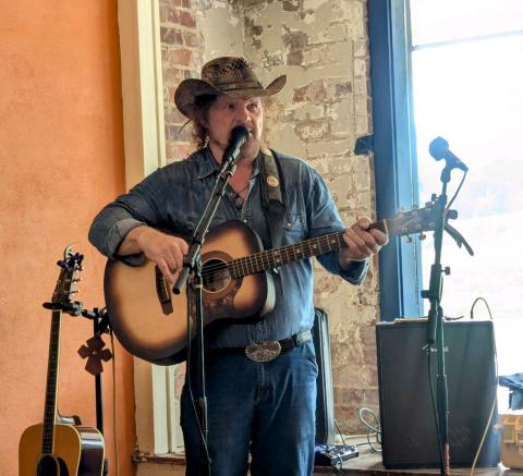 Debbie Martin/The Clayton Tribune. Tom Proctor performs at Blue Hound Barbeque in Dillard on July 19.