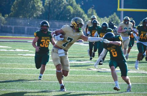 Wade Cheek/The Clayton Tribune. Rabun Gap senior tight end Marshall Pritchett stiff arms Rocket Zach Dickey en route to his touchdown reception during the Eagles’ jamboree win against AC Reynolds at Rabun County High School on Aug. 9.