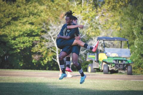 Wade Cheek/The Clayton Tribune. RGNS junior Daniel Salazar (left) and junior Tau Lamsee jump to celebrate a late goal in Rabun Gap’s 3-1 win over conference opponent Asheville Christian School on Tuesday, Sept. 10. 