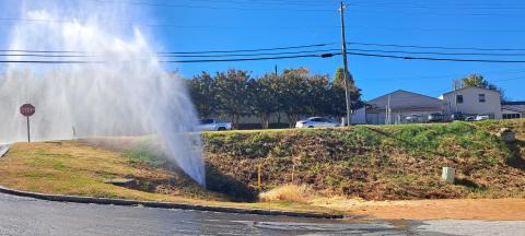 Megan Horn/The Clayton Tribune. An estimated 50,000 gallons of water was released after a four inch plastic water main developed a leak at Plaza Way on Monday afternoon. It was caused by the large amount of water received during Hurricane Helene, according to officials. 