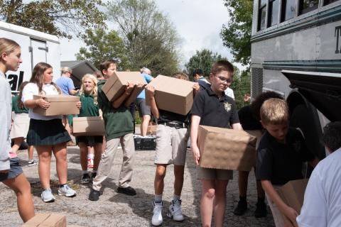 Submitted photo. Fifth graders load water onto TFS bus at Get Real Ministries before taking it to the Habersham Airport to be delivered to Western Carolina for those impacted by Hurricane Helene