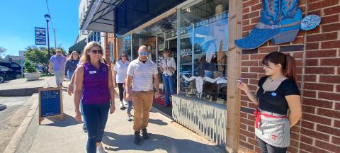 Megan Horn/The Clayton Tribune. Community members and domestic violence survivors walk in solidarity around Main Street during the third annual Hope Walk on Wednesday, Oct. 2, to bring awareness to Domestic Violence Awareness Month. During the walk, business owners and employees stood outside their storefronts with candles as a message of solidarity uniting with victims and other community members.