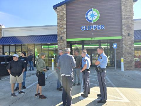 Enoch Autry/The Clayton Tribune. State representatives Lauren McDonald III and Brent Cox talk with state troopers and volunteers on their stop in Clayton on Oct. 29. Below: Michael Barlow, general manager of Troncalli Subaru of Cumming, Ga., stands with Israeli Consul General Anat Sultan-Dadon outside of Clipper Petroleum in Clayton. Barlow’s business helped fund supplies that went to Western North Carolina and Eastern Tennessee. Sultan-Dadon went with the group to provide support to the victims.