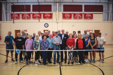 Wade Cheek/The Clayton Tribune. With Larry Walker holding the award, Rabun Pickleball Club members celebrate being named the GRPA’s statewide “Volunteer of the Year.”