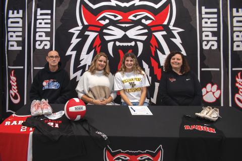 Wade Cheek/The Clayton Tribune. RCHS senior and three-sport athlete Arabella Kitchens signs her national letter of intent to compete in volleyball and track and field at William Penn University on Nov. 15. Kitchens (third from left) is joined by (from left) club volleyball coach David Provine, mother Tambrie Kitchens, and head varsity coach April Jones. 
