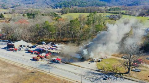 Photo courtesy of Drew Leviton. Gray smoke is seen billowing from the Marathon station in Dillard on Saturday, Dec. 7, in this aerial view captured by Drew Leviton. Firefighters work to put out the commercial structure fire at the business known locally as the Dillard Quick Shop. The cause was still undetermined and under investigation as of press time Wednesday. The building is a “total loss.”