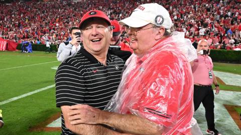 Georgia football head coach Kirby Smart (left) and father Sonny (right) share a heartfelt moment after a Bulldog victory. (Dean Legge/Dawg Post). 