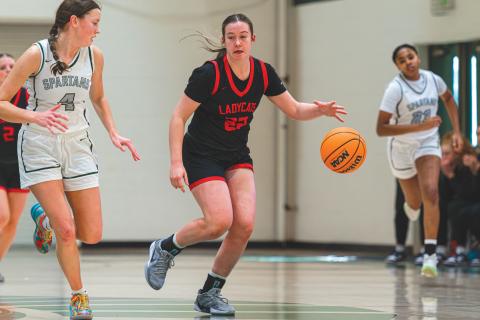 Wade Cheek/The Clayton Tribune. Senior Chloe Erlewine (22) speeds down the court with an Athens Academy defender last Saturday in a 65-32 loss to their region opponents. 