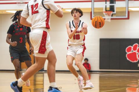 Wade Cheek/The Clayton Tribune. Senior Michael Bone completes a pass in a region bout with Providence Christian. Bone had four assists in the victory.