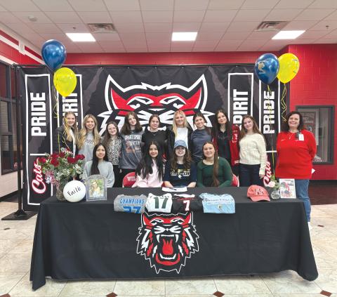 Wade Cheek/The Clayton Tribune. The 2024-25 RCHS volleyball team and others celebrated their senior setter Faith McDade on Friday, Jan. 24, as she signed her national letter of intent to play volleyball at the next level with Toccoa Falls College. McDade (seated in center) and her teammates are joined by RCHS volleyball head coach April Jones.