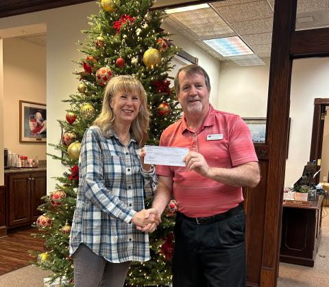 Submitted photo. Karen Bacon, Club Foundation Chair for Clayton Rotary, presents Chris DiNofrio, Treasurer for American Legion Post 220, with a check for $6,200 to support the American Legion Food Distribution Program.  