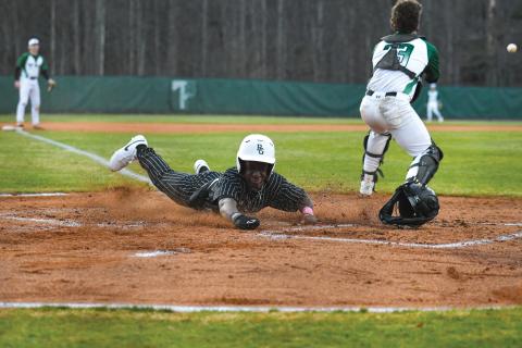 Wade Cheek/The Clayton Tribune. Senior infielder and Bryan College signee Denajh Williams dives in safely to score a run in Rabun Gap’s 19-0 win over Tallulah Falls School on Monday, Feb. 17. 