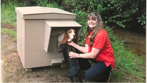 Submitted. Brenda Nash, founder and CEO of Habitat for Hounds, poses with a dog that was provided a free dog house by the nonprofit. Since 2010, over 375 dog houses have been distributed. 