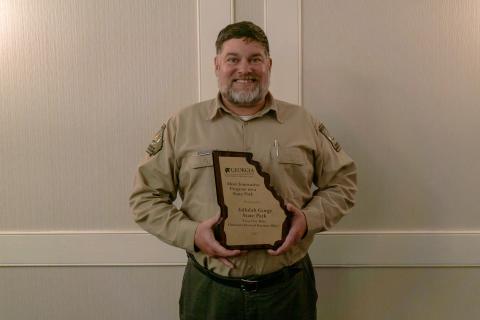 Submitted photo. Tallulah Gorge State Park won the Most Innovative Program on a State Park award. Pictured is West Malenke, Interpretive Ranger for Tallulah Gorge State Park, with the award.