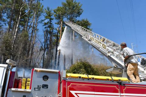 Megan Horn/The Clayton Tribune. Josh Bleckley, Rabun County Fire Services Station 2 Captain, operates Ladder 1 for a brush fire on Clayburne Street in Clayton on March 25. 