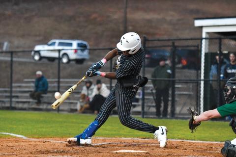 Wade Cheek/The Clayton Tribune. Senior second baseman Denajh Williams strips a base hit into the outfield in Rabun Gap’s 19-0 win over Tallulah Falls earlier this season. 