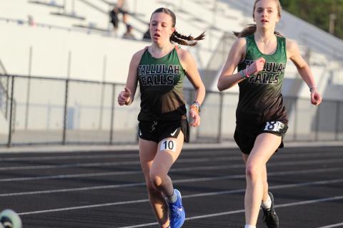 TFS Athletics. Tallulah Falls girls track and field team members Olivia Henderson and Mary Kate Ball complete a lap around the East Jackson track.