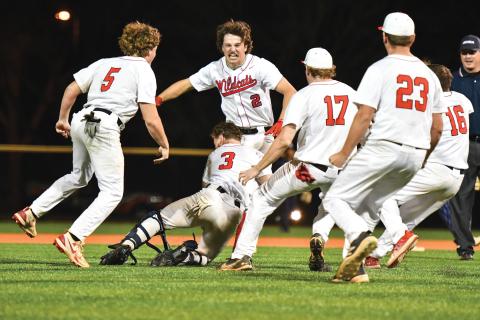 Wade Cheek/The Clayton Tribune. Rabun County junior second baseman Ty Truelove gets mobbed by his teammates after smashing a walk-off double in the Wildcats’ 5-4 win over rival Elbert County on Friday, April 4. The Wildcats also captured at 4-3 over the visiting Blue Devils in the front end of the doubleheader.