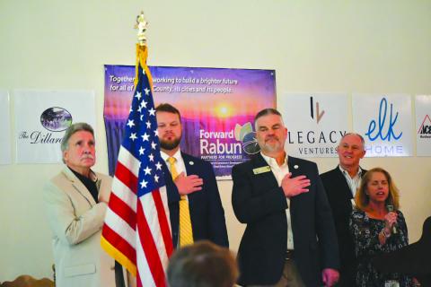 Enoch Autry/The Clayton Tribune. The Dillard House Conference Center served as the site for the Forward Rabun/Rabun County Chamber of Commerce Spring Business Breakfast as elected officials answered questions from the public. With Suzie Nixon Flaherty (far right) singing the “National Anthem,” Rabun County Commission Chair Greg James, State Sen. Bo Hatchett, State Rep. Victor Anderson and chamber president Rick Story stand at attention for the American Flag to begin the April 17 event.