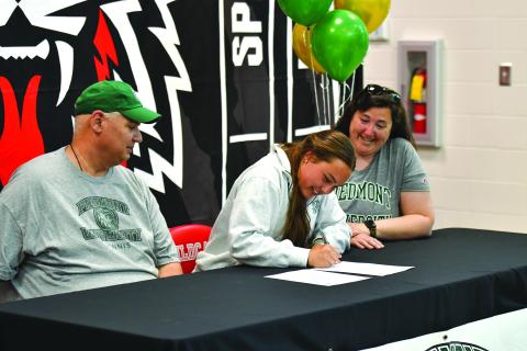 Wade Cheek/The Clayton Tribune. RCHS senior tennis player Lucy Harvey signed her national letter of intent to play tennis for Piedmont University on Friday, March 28. Harvey is currently the top singles player for the Lady Cats. 