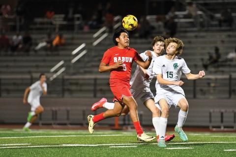 Wade Cheek/The Clayton Tribune. Junior forward Christian Avila strides down the field amid defense from Athens Academy in Thursday’s 1-0 loss to the Spartans. RCHS has one final game (Habersham) before turning its attention to the postseason.