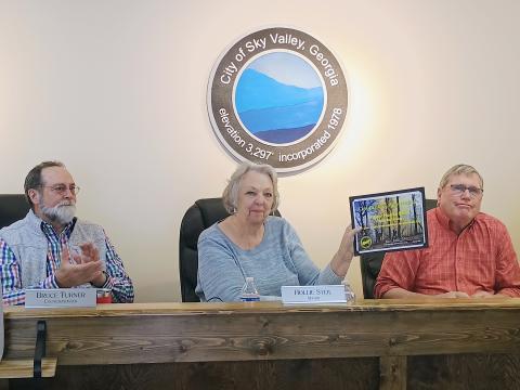 Megan Horn/The Clayton Tribune. Sky Valley Mayor Hollie Steil is presented with a Certificate of Appreciation for supporting crews fighting the Big Ridge Fire by City Manager Jason Streetman at the April 15 council meeting. Also pictured congratulating Steil are Council Members Bruce Turner and Dan McAfee. 