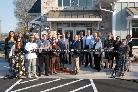 Zach Taylor/CNI News Service. Clarkesville Market Executive and Project Manager Sidney Roland cuts the ribbon with members of the Habersham Chamber of Commerce, Eclipse Brand Builders and Clarkesville officials backing him.