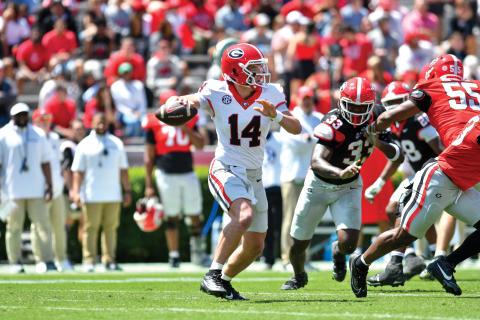 Wade Cheek/The Clayton Tribune. Former Rabun County football quarterback and potential 2025 Georgia starter Gunner Stockton surveys the field for a completion during G-Day on Saturday, April 12. Stockton completed 17-of-34 passes for 309 yards and two touchdowns as his Red team defeated the Black team 34-17 in Athens.