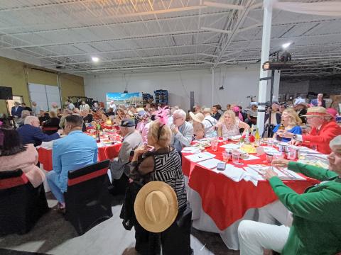 Megan Horn/The Clayton Tribune. Hundreds of people attended the Rotary Club of Clayton Run for the Roses event held at the Food Bank of Northeast Georgia on Saturday, May 3, to help raise money for youth services in Rabun County. The event featured auctions, dancing, dining and dapper attire as well as a live telecast of the 151st Kentucky Derby. 