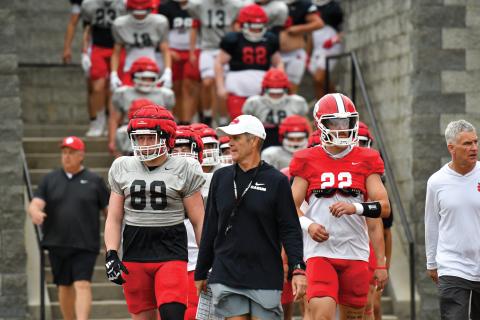 Wade Cheek/The Clayton Tribune. Seniors Ethan Hopper (left) and Ty Truelove (right) join head coach Rance Gillespie (middle) in leading the Wildcats into Frank Snyder Memorial Stadium before Rabun’s spring football game on Friday, May 16. 