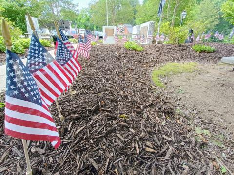 Megan Horn/The Clayton Tribune. Community members placed 48 flags at the memorial for “all who served honorably” and passed away this past year during the Monday, May 26, Memorial Day Ceremony. 
