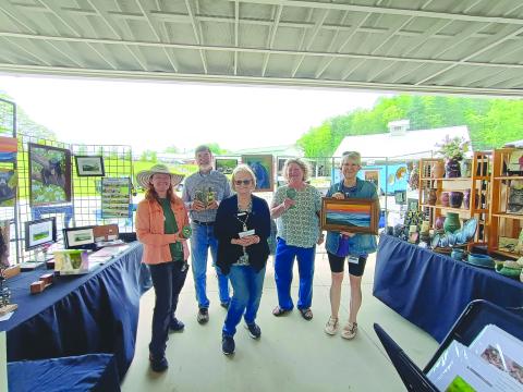 Megan Horn/The Clayton Tribune. Sassafras Artisan Market featured many creative artists from around the area. Macon County Art Association’s Uptown Gallery featured artists including Kathy Cooper with watercolor/painting; April McNiff with photography; Paul Pieringer with assemblage sculptures; Kay Wolf with pottery; and Kathleen Woodring with jewelry. 