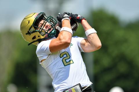 Wade Cheek/The Clayton Tribune. Wideout Walker Bryson tries to snag an over-the-shoulder catch in a 7-on-7 matchup at the University of Georgia on Tuesday, June 10.