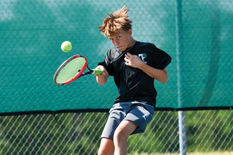 Wade Cheek/The Clayton Tribune. Ethan Alderfer rallies back and forth with his opponent at the Tallulah Falls School kids tennis camp last week. 