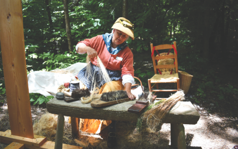 File/Megan Horn/The Clayton Tribune. Flax demonstrator Carol Salloum with the group “Southeastern Civilian Living Historians” demonstrates how Flax seed becomes linen during Foxfire Heritage Days last year. Many demonstrators are expected again this year for the 17th annual Heritage Days June 6 and 7. 