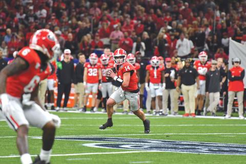 Wade Cheek/The Clayton Tribune. Georgia quarterback Gunner Stockton scrambles to complete a pass to wide receiver Dominic Lovett in January’s Sugar Bowl loss to Notre Dame. Stockton, tops on the UGA depth chart heading into the 2025 football season, was a state record-setting quarterback for Rabun County.