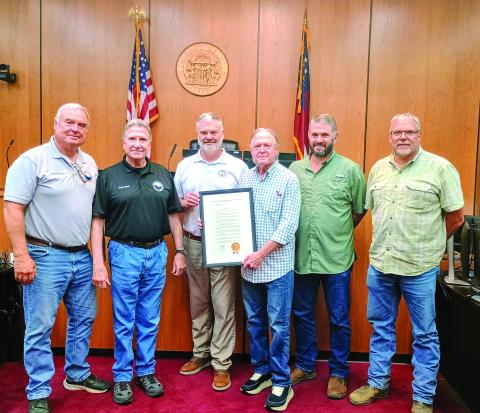 Megan Horn/The Clayton Tribune. Commissioners are presented with a resolution proclaiming Rabun County as the “Waterfall Capital of Georgia” during the July 22 Board of Commissioners meeting. Pictured are Commissioner Kent Woerner, left; Chairman Greg James; Georgia District 10 Rep. Victor Anderson; Andrew Harris, Lake Burton resident who drafted the resolution and spearheaded the designation; and Commissioners Will Nichols and Tom Garrison. Not pictured is Commissioner Scott Crane. 