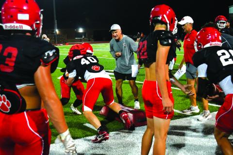Enoch Autry/The Clayton Tribune. Rabun County coaches Bill Stewart and Rance Gillespie watch Wildcat players run a drill at the annual “Midnight Madness” on July 28. 