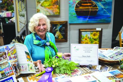 Photo courtesy Mark Barton. Diane Rush was the winner of this year’s “People’s Choice Award for Best in Show” after attendees at the Painted Fern Art Festival cast their ballots Saturday, July 12, and Sunday, July 13. Rush exhibited her colorful paintings, many of which capture historic landmarks in and around Clayton. Several of her paintings also showcase the beautiful wildlife and nature in the Northeast Georgia area. 
