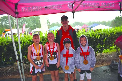 Submitted Photo. From left, top runners Keegan Hanifan-Wagner (10U), Harper Westbrook (10U), Nora Webb (8U), and Owen Moseley (10U) stand with Head Coach Ed Eidson at Athens Christian School on Aug. 23.