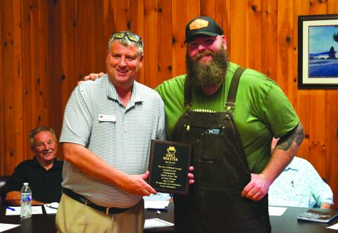 Enoch Autry/The Clayton Tribune. Dillard Mayor Claude Dillard presents Kyle Bryner with a plaque from the City of Dillard for the owner of Blue Hound’s reality cooking show win on the Food Network’s “BBQ Brawl” for season six.