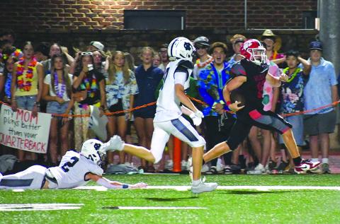 Enoch Autry/The Clayton Tribune. Rabun County senior running back Reid Giles sprints down the sideline in front of a group of RCHS students on Aug. 15 for a 65-yard touchdown against visiting White County in the Wildcats’ 42-6 win on “Hall of Fame Night.” Giles, a preseason all-state selection, scored three TDs.