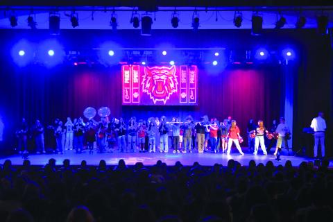 Enoch Autry/The Clayton Tribune.  The Rabun County Marching Wildcat Band performs for the RCHS student body on the first day of school on Monday, Aug. 4, inside the Fine Arts Building with pyrotechnics going off on the sides of the stage. This year’s band has grown in numbers up to 83.