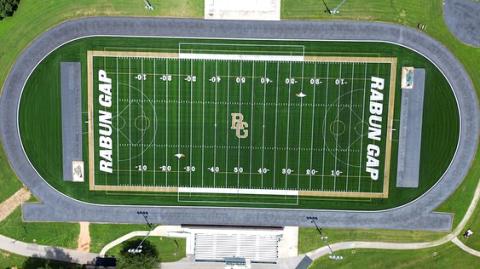 Submitted Photo.  An aerial view shows the newly installed Rabun Gap turf field that was bought through donations to the athletic program. BELOW RIGHT: The RGNS weight room has been expanded with new equipment.