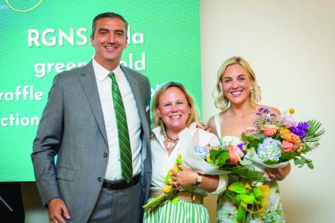 Submitted. Rabun Gap-Nacoochee School celebrated its third annual Green & Gold Gala on Saturday, Aug. 23, at The Dillard House. Pictured, Head of School Jeff Miles recognizes Gala co-chairs and current parents Sarah Barge and Andrea Sorgeloos. The gala raised $260,500 for Rabun Gap students, teachers and programs.