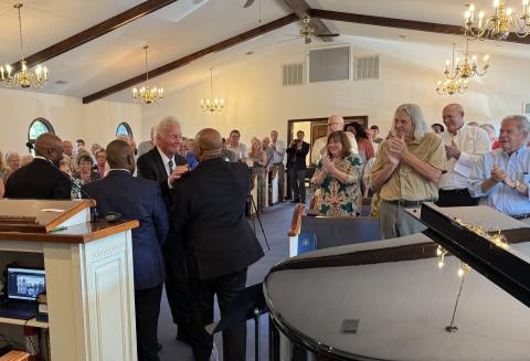 Submitted. letcher Wolfe of Sky Valley greets former members of the Atlanta Boy Choir at Rabun Gap Presbyterian Church at a Sunday concert. Wolfe founded and directed the choir for 60 years.