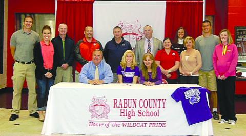 Submitted Photo. Rabun County’s Sally Woerner (seated, center) is surrounded by family and friends as she signs a national letter of intent to play at Western Carolina University.