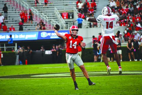 Wesley Branch/The Clayton Tribune. Former Rabun County and current UGA quarterback Gunner Stockton throws a pass versus Austin Peay in Georgia’s 28-6 win over the Governors on Sept. 6. Stockton threw for 227 passing yards in the game, completing 26-of-34 passes. 