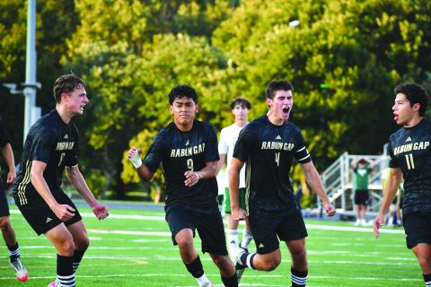 Wesley Branch/The Clayton Tribune. Rabun Gap junior Jose Luis Carrillo (No. 9, center) celebrates a goal with his teammates versus Christ School on Sept. 11. The game was canceled by the officials with 28 minutes remaining. 