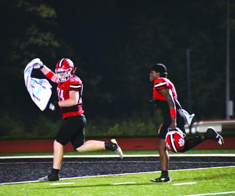 Enoch Autry/The Clayton Tribune. Ryan Yearwood and JK Fruster celebrate the Wildcats’ win over Fannin County on Aug. 22 as they run to ring the bell.